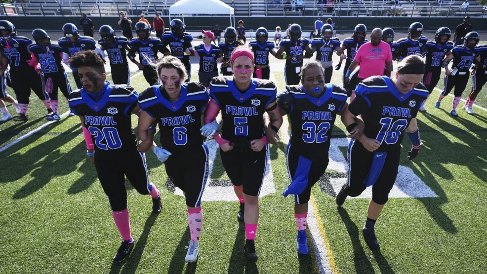 women's football team walking together on the field
